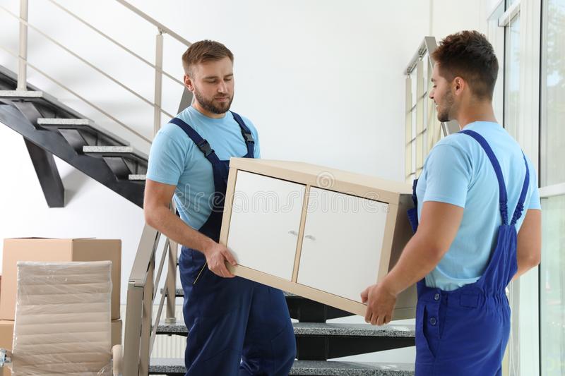 professional workers carrying cabinet stairs moving service professional workers carrying cabinet stairs office moving 159466308