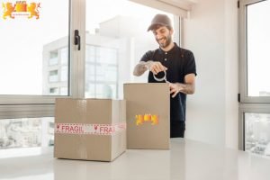 delivery man taping up cardboard boxes 23 2147862247 1